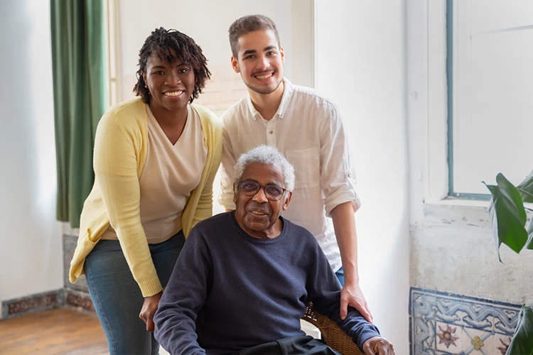 Family Support and Independent Living – Possum Homecare Solutions Happy family supporting an elderly man at home, representing independent living and homecare solutions