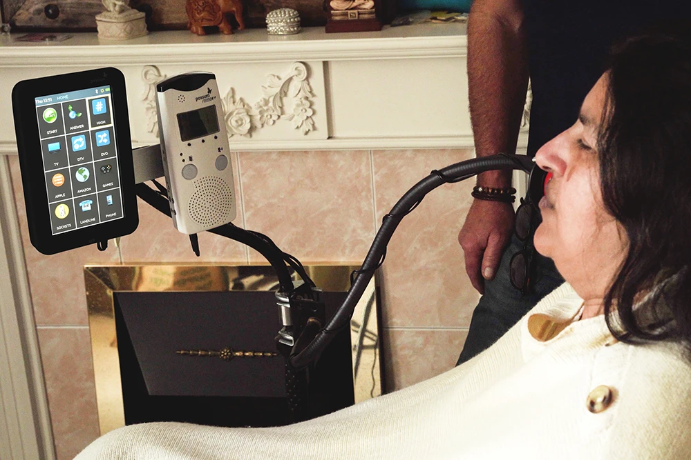 All-in-One Assistive Technology System user operating an all-in-one assistive technology system with environmental control, door entry and communication functions
