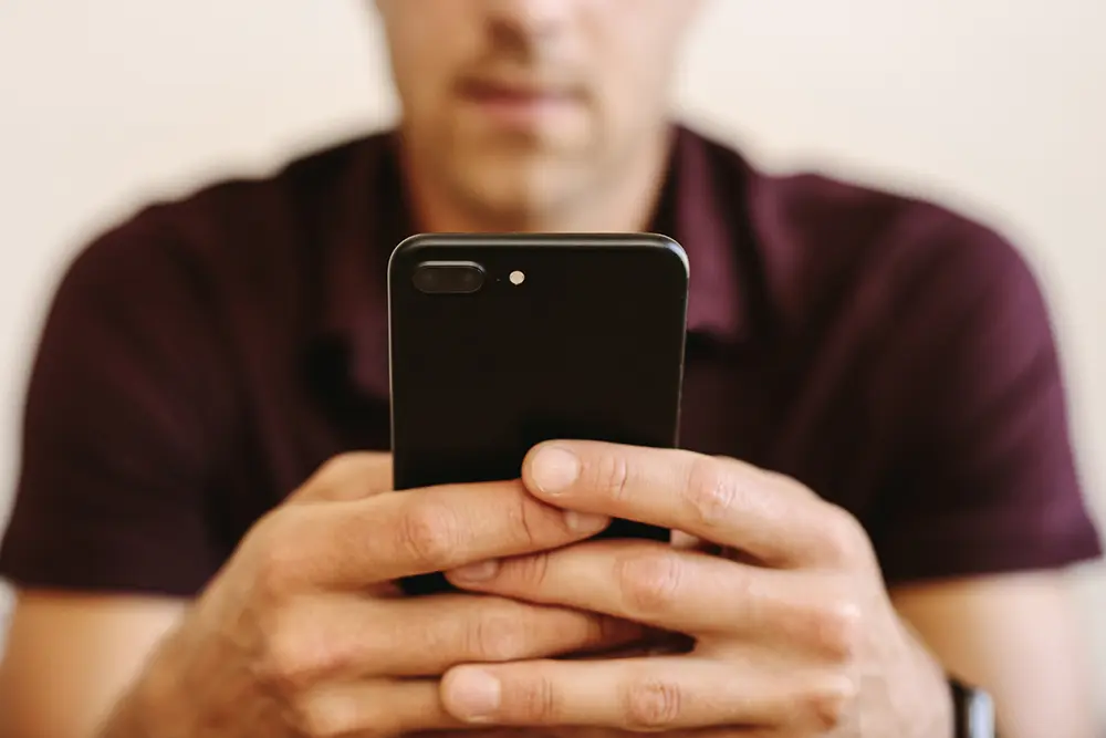 Instant Caregiver Alerts Caregiver receiving an instant seizure alert on a smartphone