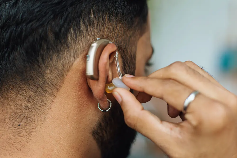 Supporting People with Hearing Impairments Person wearing a hearing aid, representing accessible visual telecare alerts