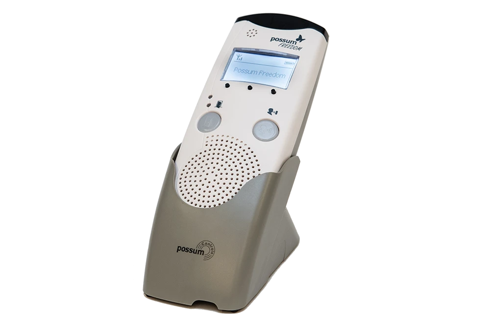 Possum Freedom Accessible Communication Device Possum Freedom communication device with caller ID display and accessible controls in charging cradle