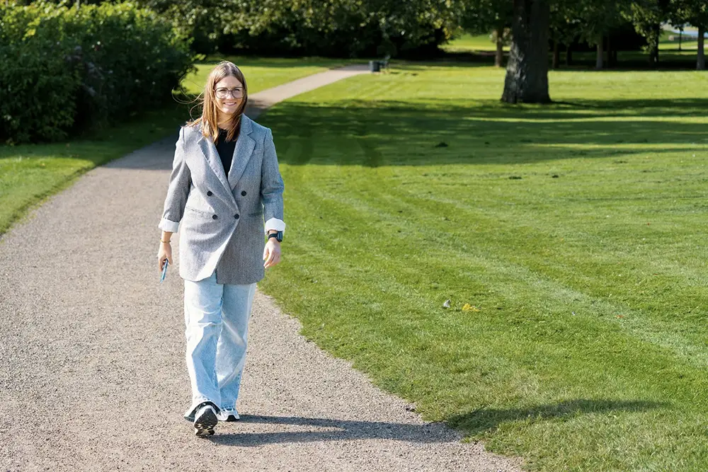 Smart Seizure Detection for Independent Living Person walking outdoors wearing a seizure monitoring device that provides smart seizure detection and supports independent living