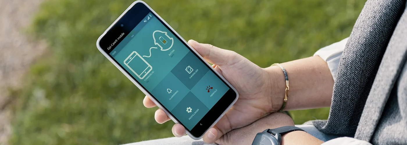 Epi Care Mobile App for Epilepsy Monitoring Person using the Epi Care Mobile app on a smartphone to monitor epilepsy safety and alerts