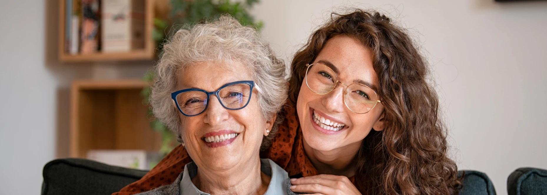 Fall Detection and Reassurance at Home elderly woman and carer smiling together at home representing fall detection support and reassurance