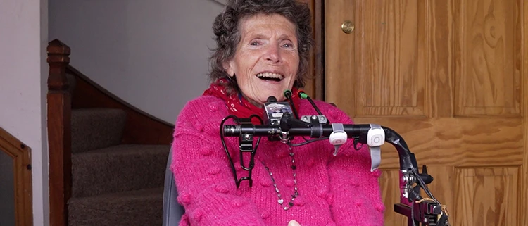 Wheelchair Mounted Environmental Controller woman using a wheelchair-mounted environmental controller and assistive access system at home