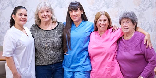 Staff Protection Solutions for Care Teams Care staff and residents together in a care home, representing staff protection solutions that help teams raise the alarm and receive support when needed