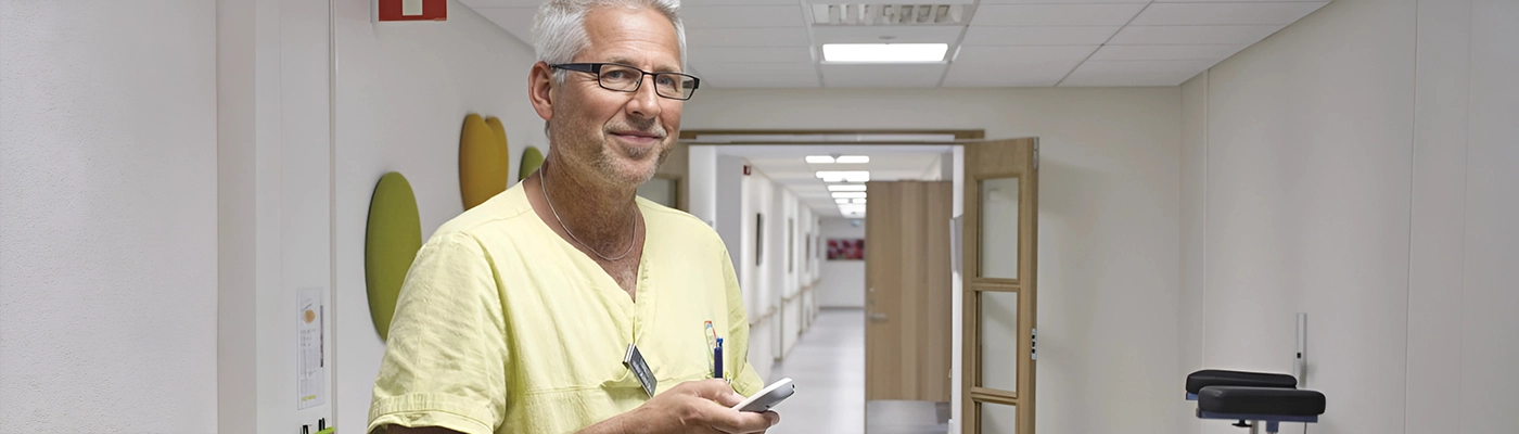 Nurse Call Systems Healthcare professional using a nurse call system in a hospital corridor to improve patient safety and response times