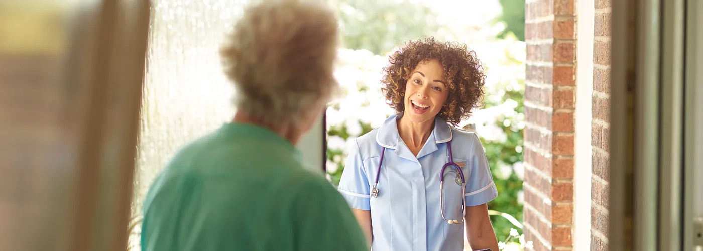 Domiciliary Care and Home Support Community nurse visiting an older person at home to provide domiciliary care and support