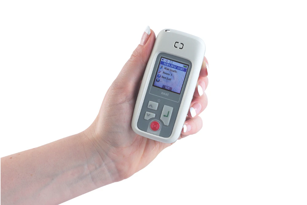 Hand holding an Emfit pager displaying an epilepsy seizure alert notification for carers