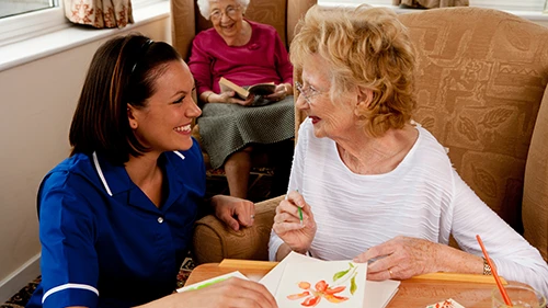 Improved Staff Awareness Care worker engaging with residents in a care home to support personalised care