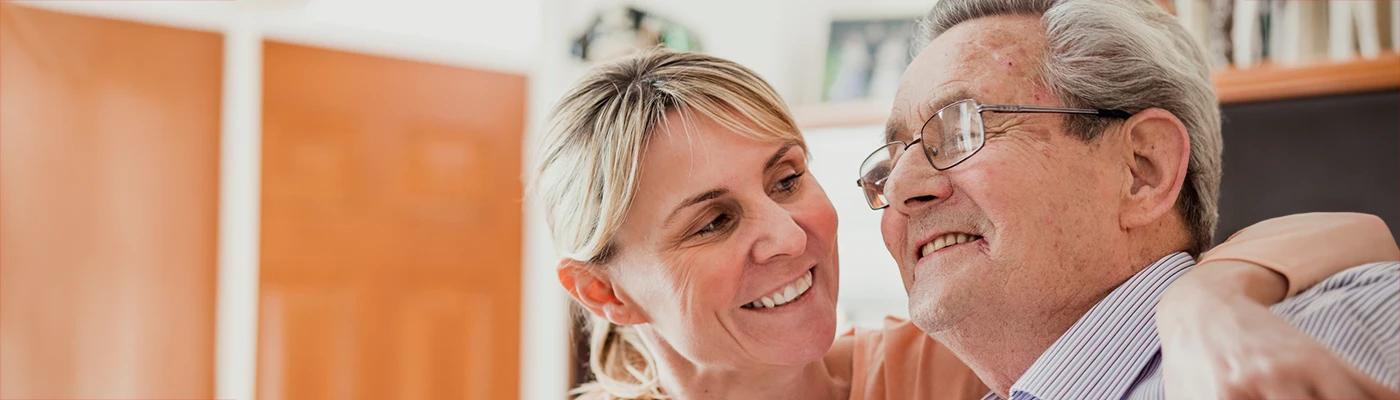 Possum Telecare Services and Support Carer supporting an older man at home, representing Possum's telecare services and personalised independent living support.